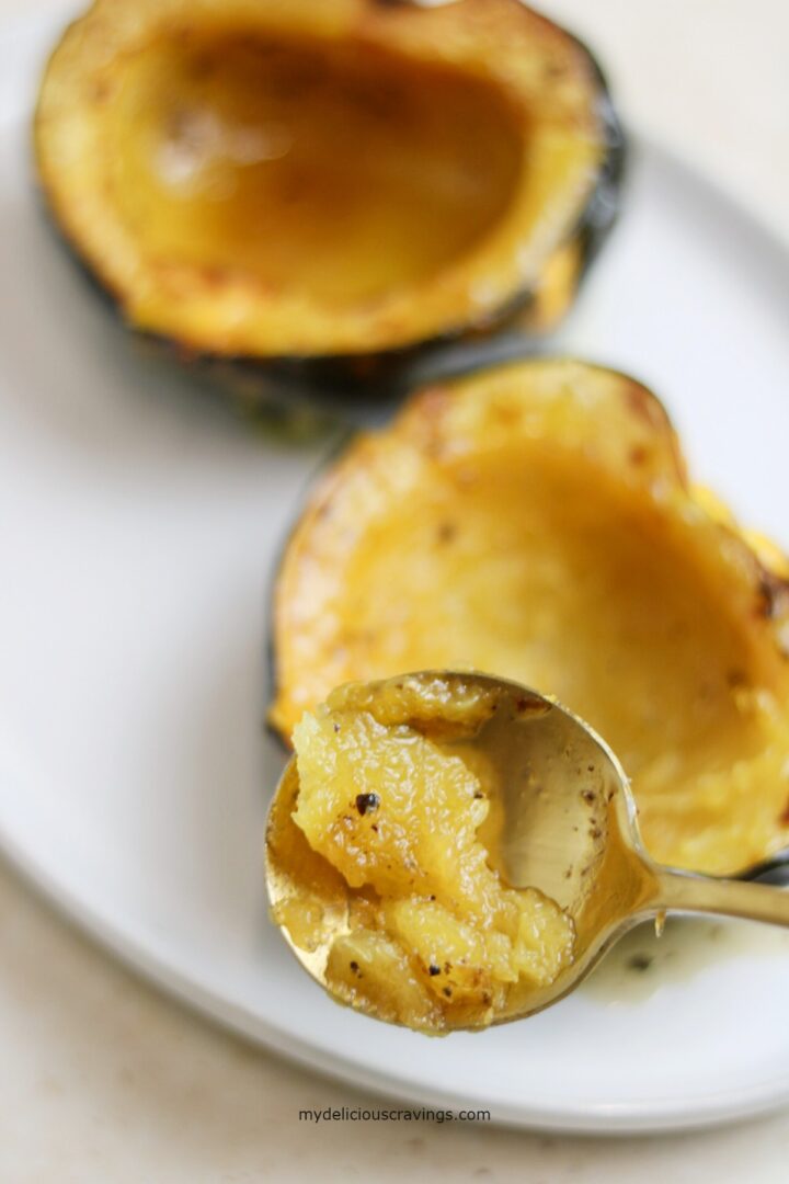 a spoon scooping cooked acorn squash.