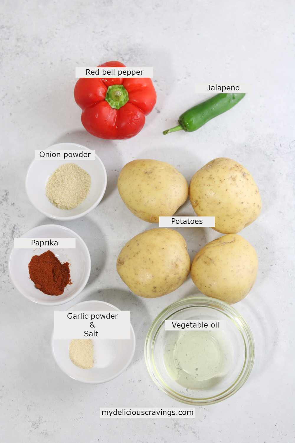 Ingredients for making air fryer breakfast potatoes with peppers displayed on the counter. 